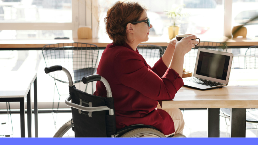 vrouw in rolstoel achter laptop